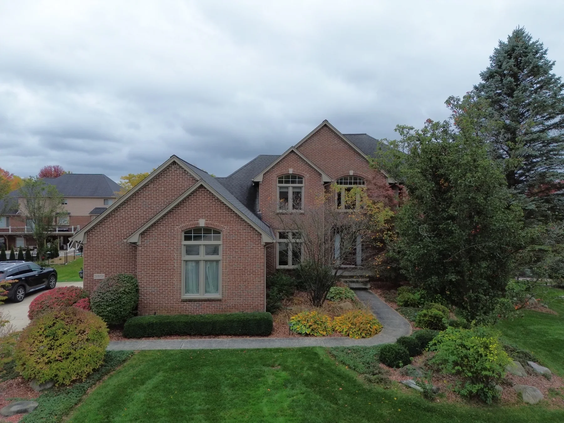 Aerial view of brick home and landscaped front yard