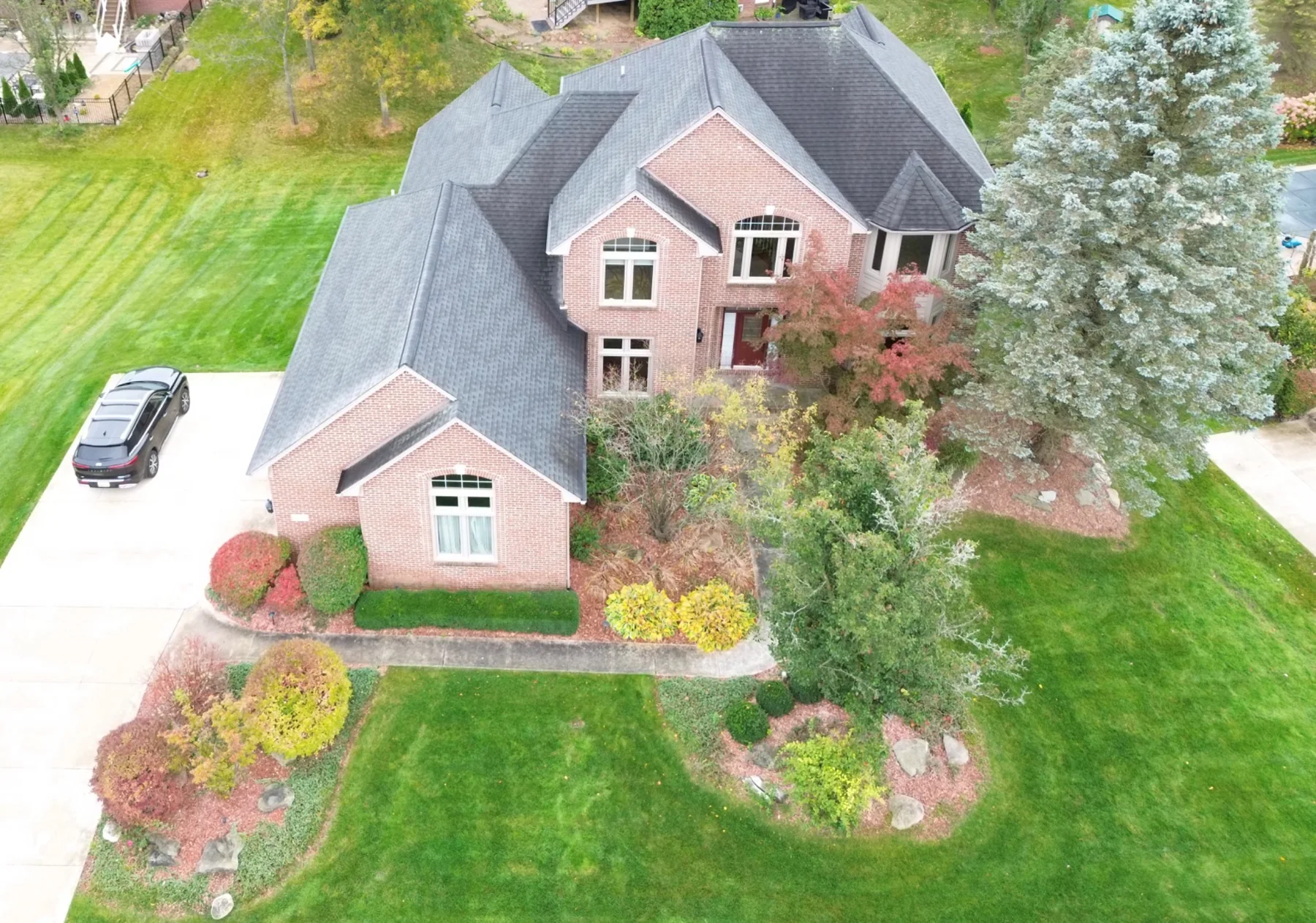 Elevated view of brick house and landscaping