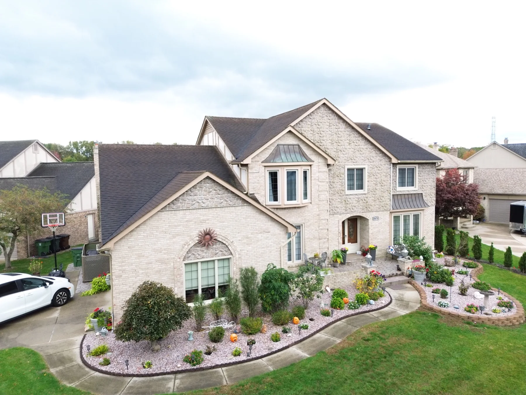 Aerial photograph of stone-front residence and gardens